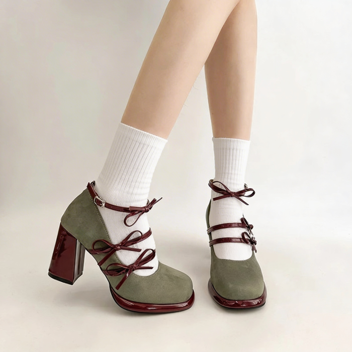Green high-heeled shoes with red accents worn with white socks on a neutral background | Coquette Bow Mary Janes | Aesthetic Shoes