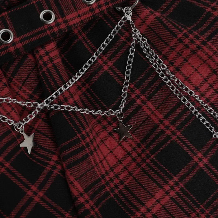 Silver chain with star pendants on a red and black plaid fabric background