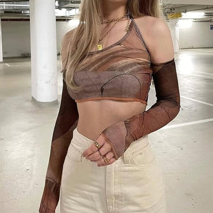 Brown Y2K Halter Crop Top - Brown Y2K Alternative Crop Top. A woman wearing a sheer brown and taupe mesh long-sleeve crop top with a scoop neckline, styled with cream-colored jeans in a parking garage.