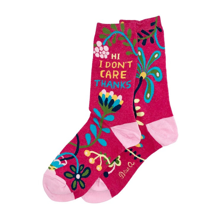 I Don't Care Socks – Pink Floral Y2K Crew Socks. A pair of bright pink crew socks with a colorful floral pattern and the text 'HI I DON'T CARE THANKS' printed on the side.