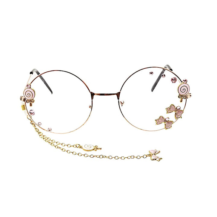 Pink Charm Glasses - Round Aesthetic Glasses. Round metal eyeglasses with decorative pink and gold charms, including swirls, hearts, and a dangling gold chain, shown on a plain white background.